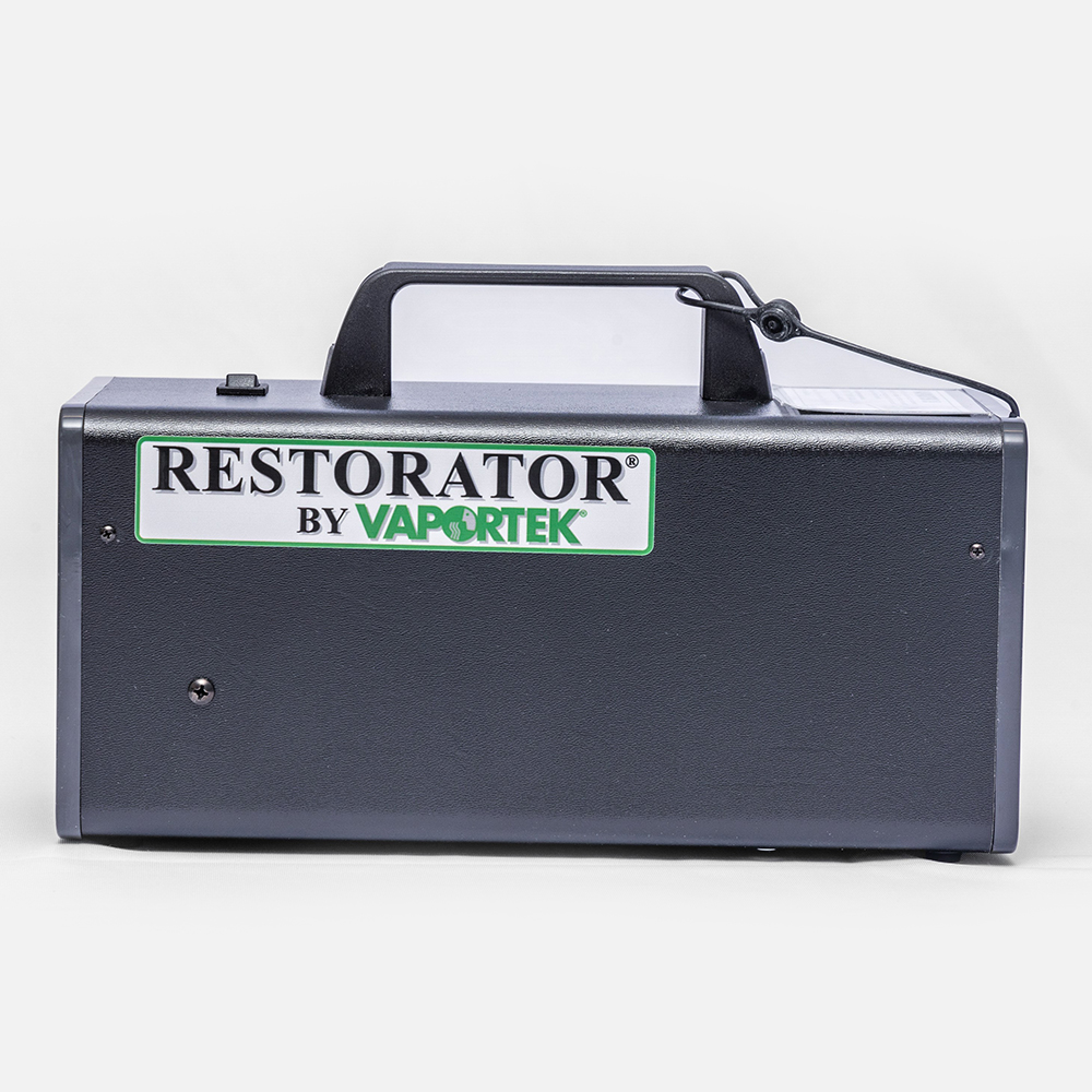 The Restorator® is a black and gray portable device with a handle and rectangular body, designed for odor control or restoration.