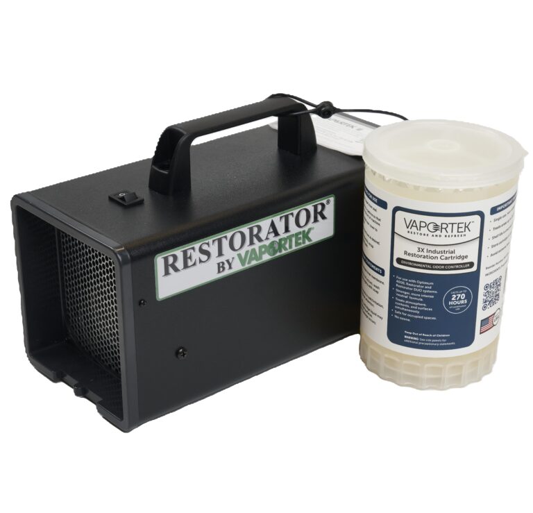 A black portable machine labeled “Restorator by Vaportek” sits beside a white cylindrical container labeled “Vaportek RX Industrial Restoration Cartridge” on a white background.